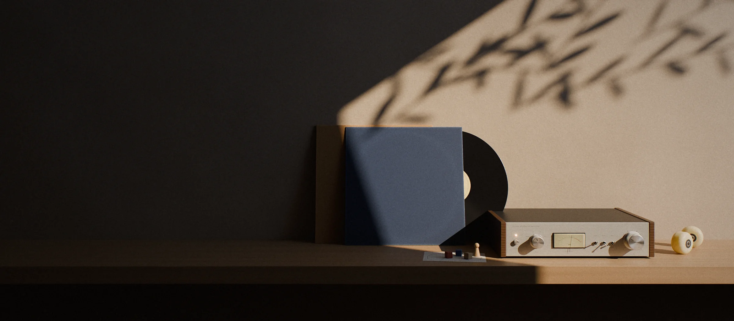 Late afternoon sun across a studio shelf: a blue record sleeve with the record half out, wooden game pieces on a hand-drawn map, a silver hi-fi amplifier and two butter-yellow skateboard wheels, with leaf shadows on the wall.